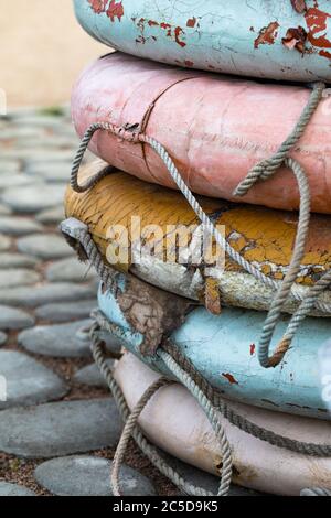 Close up of old weathered lifebuoys awaiting restoration and painting. Vertical shot. Stock Photo