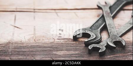 old wrenches on a wooden background with copy space Stock Photo
