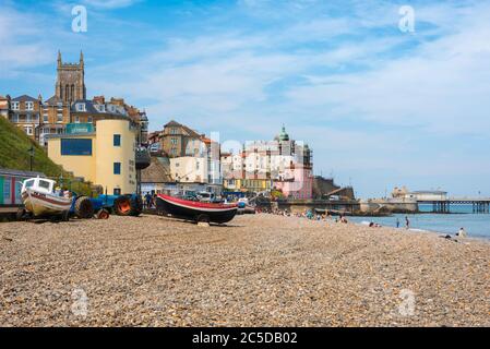 Cromer beach UK, view in summer of people sunbathing on the beach at Cromer on the north Norfolk coast, East Anglia, England, UK. Stock Photo