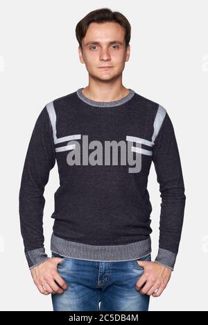 Handsome man wearing sweater isolated on gray studio background Stock Photo