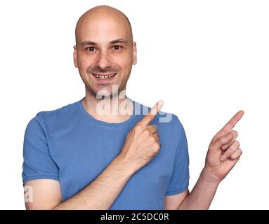 40s happy bald man pointing his fingers aside. Isolated on white Stock Photo