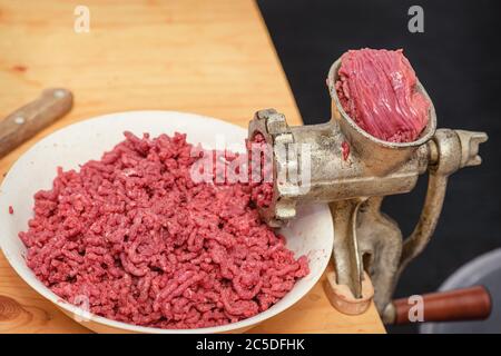 Meat-grinder, grinding fresh meat into minced meat Stock Photo - Alamy