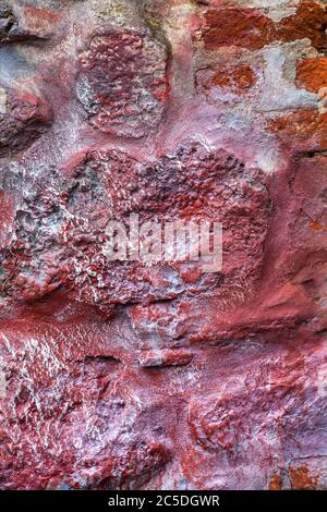 Old abstract red blue multi coloured painted stone brick wall texture background Stock Photo