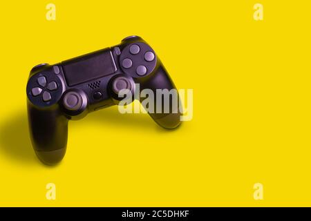 Video game joystick isolated in yellow background. Stock Photo
