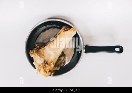 Raw stew beef bone soup in a pan isolated on white background. Stock Photo