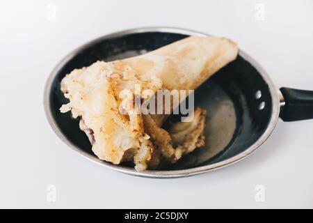 Raw stew beef bone soup in a pan isolated on white background. Stock Photo