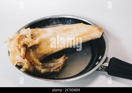 Raw stew beef bone soup in a pan isolated on white background. Stock Photo