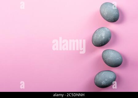 Four easter eggs in color of concrete on pink background. Top view, flat lay. Copy space. Happy Easter concept. Easter greeting card Stock Photo
