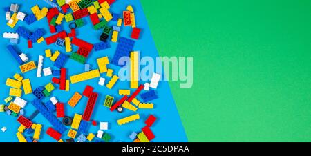 Vilnius, Lithuania - February 23, 2019. Colorful lego blocks on light blue and green blackground. Top view Stock Photo