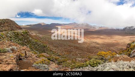 Panoramic view of the Plaine des Sable with way to volcano Piton de la Fournaise at island La Reunion Stock Photo