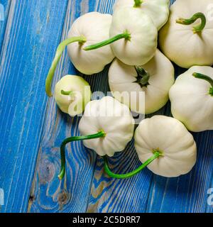 Harvest of organic garden vegetables. Young patisons lie on a wooded table