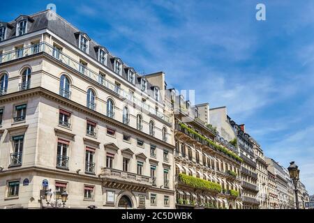 Paris, France - June 29, 2015: Rue de la Paix. Beautiful facades of old buildings with green plants Stock Photo