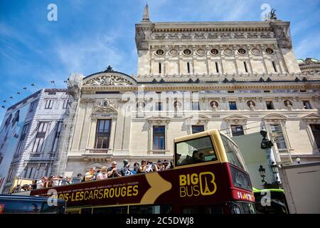 Paris, France - June 29, 2015: Excursion bus with tourists near the western facade of the Palais or Opera Garnier & The National Academy of Music (Gra Stock Photo