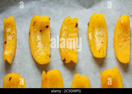 Bright slices of bell pepper prepared for baking in the oven. Soft focus. Stock Photo
