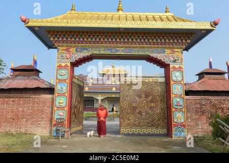 Lumbini, Nepal - 18 January 2020: monk in front of the entrance door at the monastic zone of Lumbini on Nepal Stock Photo