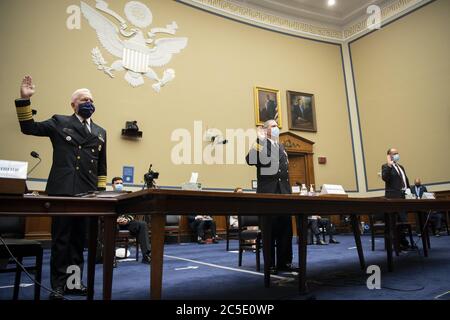 Admiral Brett P. Giroir, M.D., Assistant Secretary for Health, left, Rear Adm. John Polowczyk, leader of the Supply Chain Stabilization Task Force and vice director of logistics of the Joint Chiefs of Staff, and Kevin Fahey, assistant Defense secretary for acquisition, swear in before testifying during a House Oversight and Reform Committee hearing on 'The Administration's Efforts to Procure, Stockpile, and Distribute Critical Supplies' in the Capitol in Washington, DC on Thursday, July 2, 2020. Pool Photo by Caroline Brehman/UPI Stock Photo