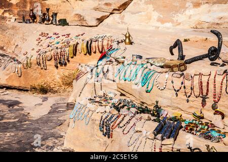 Tourist souvenirs on display in Siq Al-Barid or Little Petra in Jordan. Stock Photo