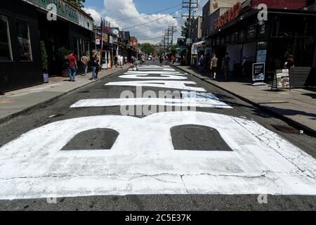 Kensington Market area. Toronto Ontario Canada. Bold white mural painted on street. Stock Photo