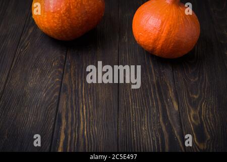 Halloween holiday background with pumpkins on a dark wooden table Stock Photo