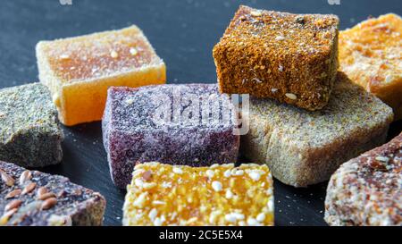 Arab sweets on dark background. Middle eastern dessert food from natural fruits. Assorted turkish delight candies. Set of oriental eco sweets. Stock Photo