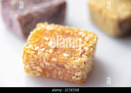 Arab sweets on white background. Middle eastern dessert food from natural fruits. Turkish delight candies close-up. Set of oriental eco sweets. Stock Photo