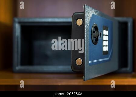 Open empty safe box in hotel room or home. Focus on the lock. Stock Photo