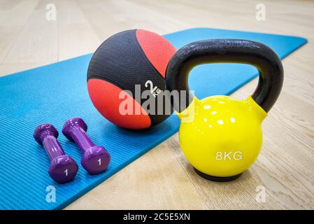 Mat for fitness classes with dumbbells, weight and ball Stock Photo