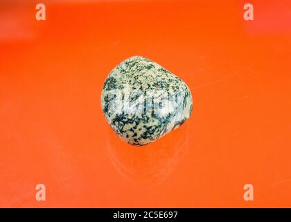 white agate with green inclusions and a smooth surfaceing stone Stock Photo