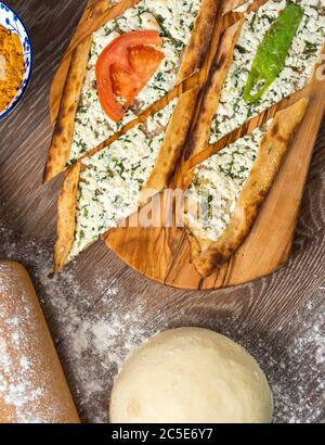 Traditional turkish baked dish pide. Turkish pizza pide, Middle eastern appetizers. Turkish cuisine. Top view. Pide with cheese filling Stock Photo