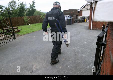 Police officers search a house in Newry, Co Down as part of Operation Venetic, an investigation on Encrochat, a military-grade encrypted communication system used by organised criminals trading in drugs and guns. Stock Photo