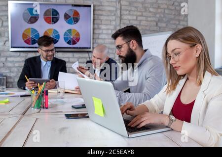 Team of young business people and designers working on new projects and discussing new business ideas. Startup concept. Stock Photo