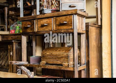 Wooden furniture, more or less antique, are on sale in a shop in the artisan market of Cuenca, Stock Photo