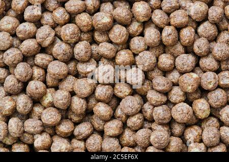 Breakfast cereal dry chocolate puff balls with no milk, full frame macro image with copy space. Stock Photo