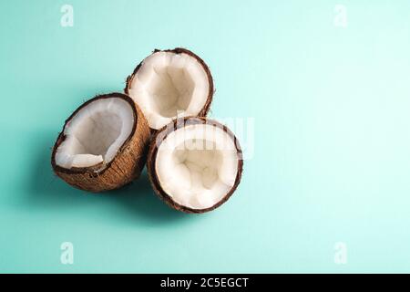 Coconut fruits on blue vibrant plain background, abstract food tropical concept, angle view copy space Stock Photo