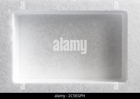 Polystyrene or styrofoam padding for product packaging. Detail of styrene foam plastic box close-up. White styrofoam cushion texture background. Stock Photo