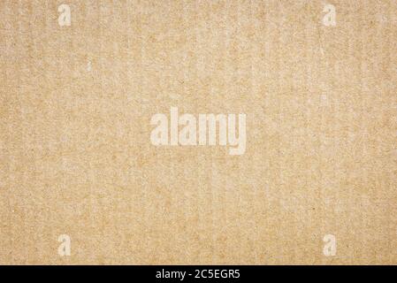 Paper cardboard background. Natural corrugated carton sheet. Kraft cardboard texture with vertical stripes. Seamless light brown paperboard for backgr Stock Photo