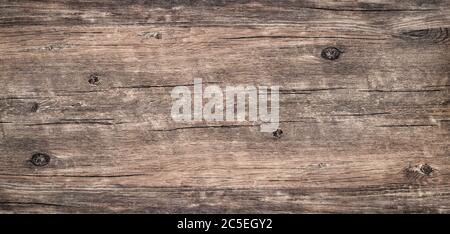 Wood texture background. Top view of dark vintage wooden table with a cracks. Brown rustic rough wood for backdrop. Surface of old knotted wood with n Stock Photo