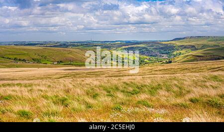 Dan Clough Moss looking toward the village of Marsden with Emley Moor Transmitting Station in the distance. Stock Photo