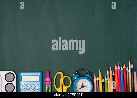 Back to school concept. Top above overhead view photo of colorful stationery isolated on greenboard Stock Photo