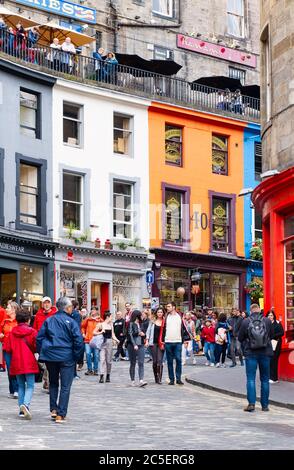 Colorful shopfronts and tourists at the famous Victoria Street in Edinburgh