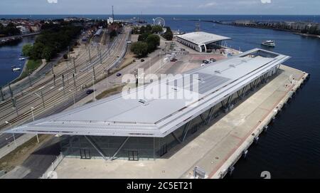02 July 2020, Mecklenburg-Western Pomerania, Warnemünde: The new cruise terminal "Warnemünde Cruise Center 8" will be presented at a press event. The 15 million euro terminal extends the existing cruise port of the Baltic Sea resort. (Aerial view with a drone/helicopter) Photo: Bernd Wüstneck/dpa-Zentralbild/ZB Stock Photo