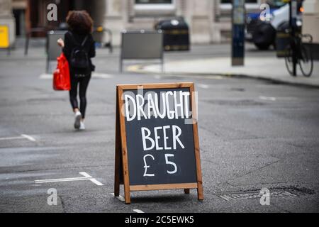 London, UK.  2 July 2020.  A sandwich board advertises draught beer on sale for takeaway at a restaurant in Covent Garden.  The UK government will allows pubs to reopen on 4 July as further coronavirus pandemic lockdown restrictions are relaxed.  Critics have said that a more cautios reopening for pubs should take place, on a Monday instead of a Saturday. Credit: Stephen Chung / Alamy Live News Stock Photo