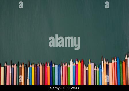 Top above overhead view photo of colorful pencils isolated on greenboard Stock Photo