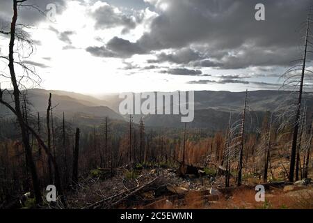 View from Wawona Road in Yosemite National Park, California towards Stanislaus National Forest.  Prescribed burn of area and a cloudy day. Stock Photo