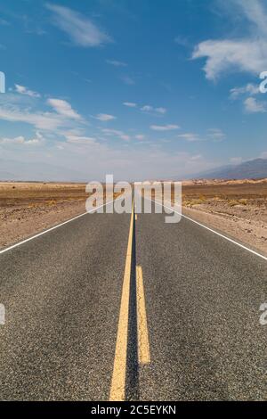 Looking along a long, straight road in Death Valley National Park, California Stock Photo