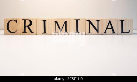Criminal word from wooden cubes. Crime and crime concept. Close up. Stock Photo