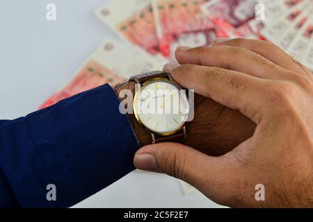 Premium Photo | Wrist watch on dollars background business concept