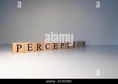 Perception text from wooden cubes. Photo was taken in a white background. Stock Photo