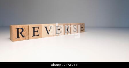 Reverse text from wooden cubes. Photo was taken in white background. Stock Photo