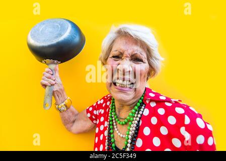 Happy and playful senior woman having fun - Portrait of a beautiful lady above 70 years old with stylish clothes, concepts about senior people Stock Photo